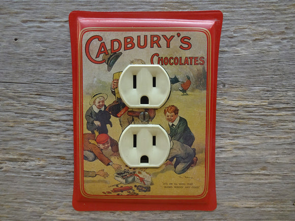 Outlet Cover Made From A Red Cadburys Chocolate Tin